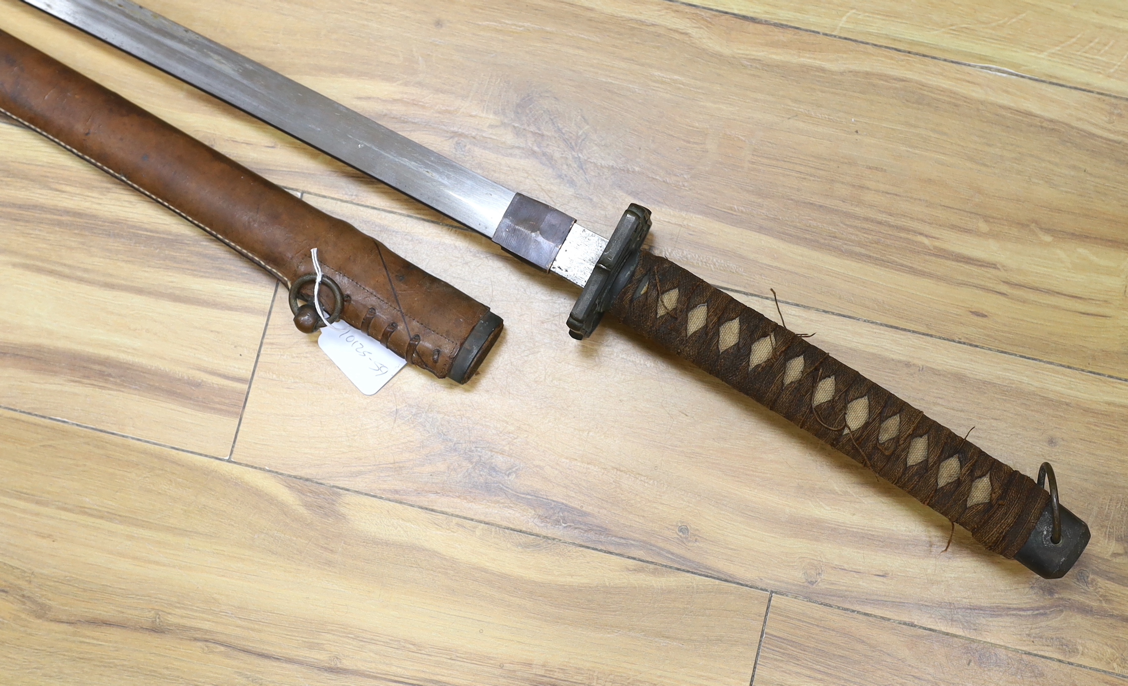 A Japanese WWII Shin gunto (sword) and leather mounted scabbard